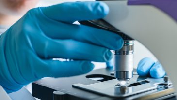 Scientist,Hands,With,Microscope,Close-up,Shot,In,The,Laboratory