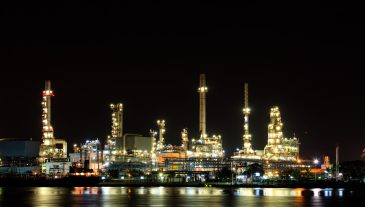 Oil refinery at night with reflection