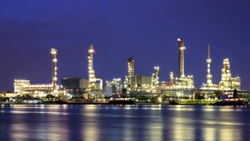 Oil refinery at twilight with reflection