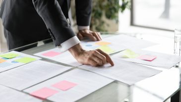 Close,Up,Businessman,Working,With,Documents,,Reading,Notes,On,Colorful