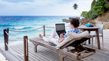 Man,With,Laptop,And,Mobile,Phone,Running,Remotely,On,Colorful